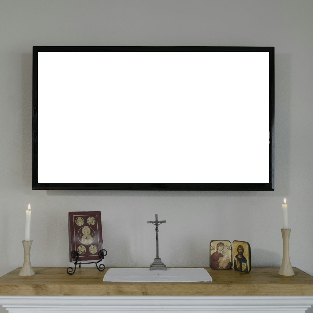 black flat screen tv mounted on white wall