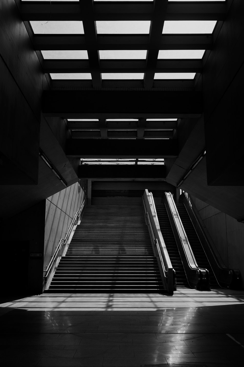 grayscale photo of a escalator