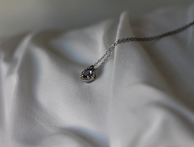 silver necklace with black gemstone pendant