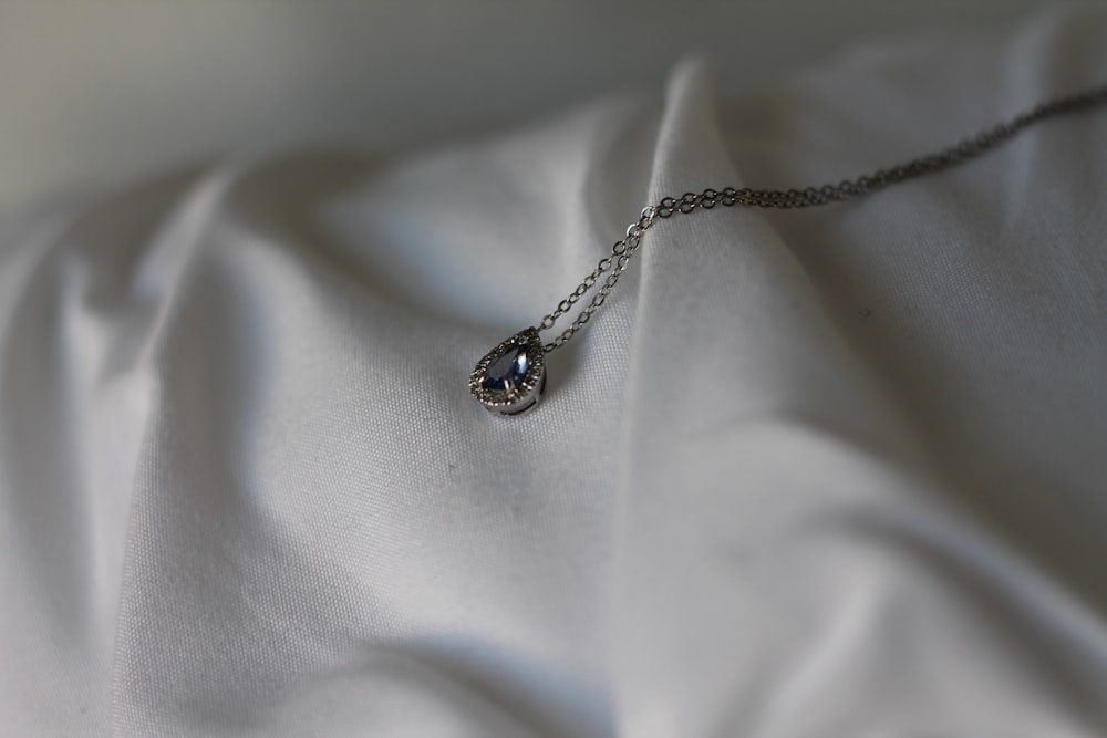 silver necklace with black gemstone pendant