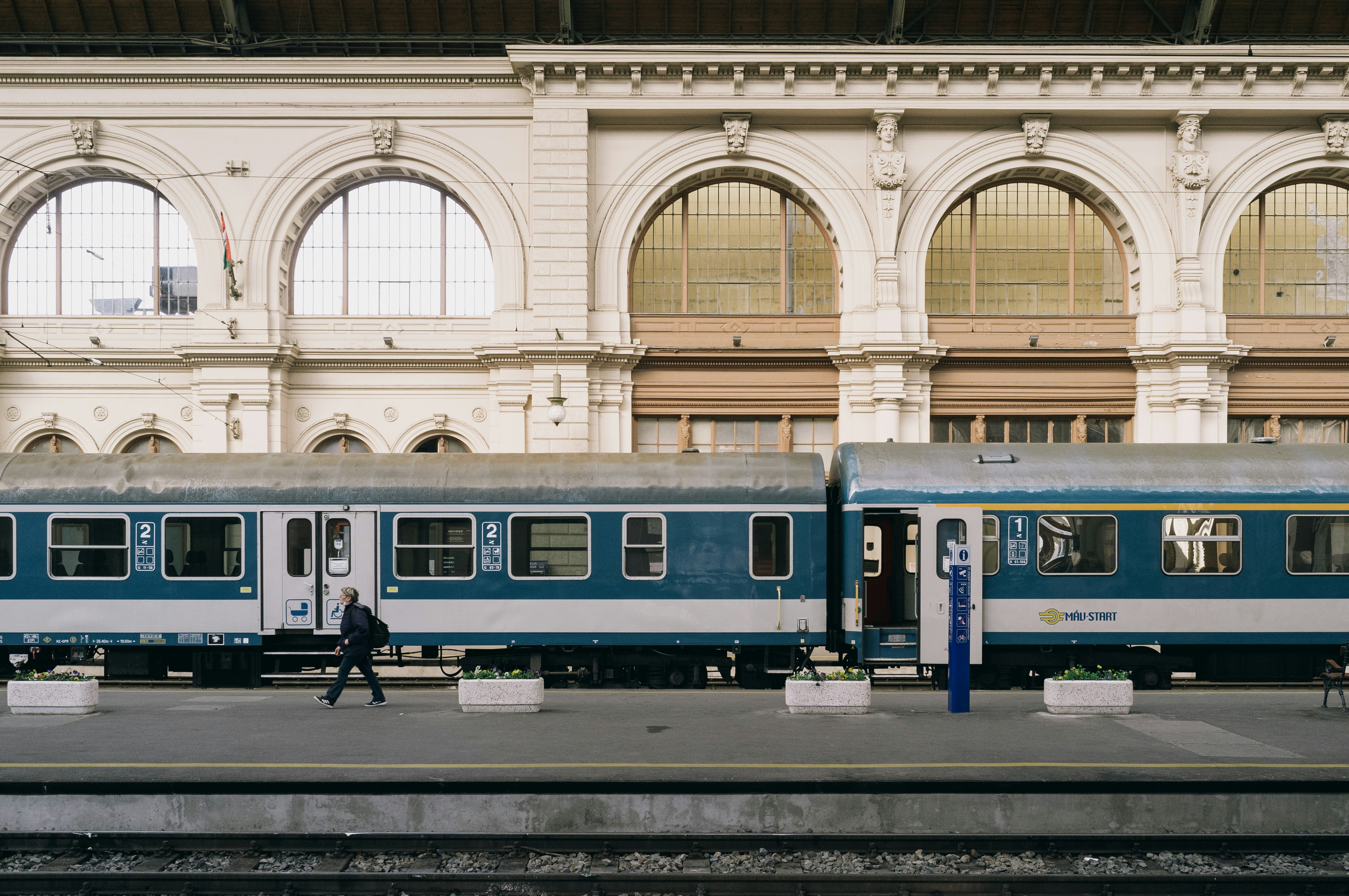 blue and white train in train station, 