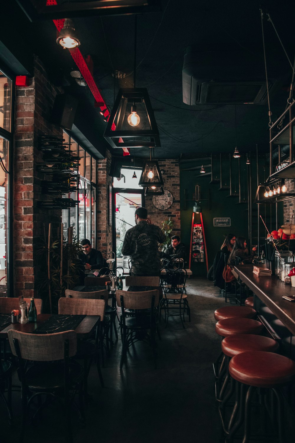 people sitting on brown wooden chairs inside restaurant