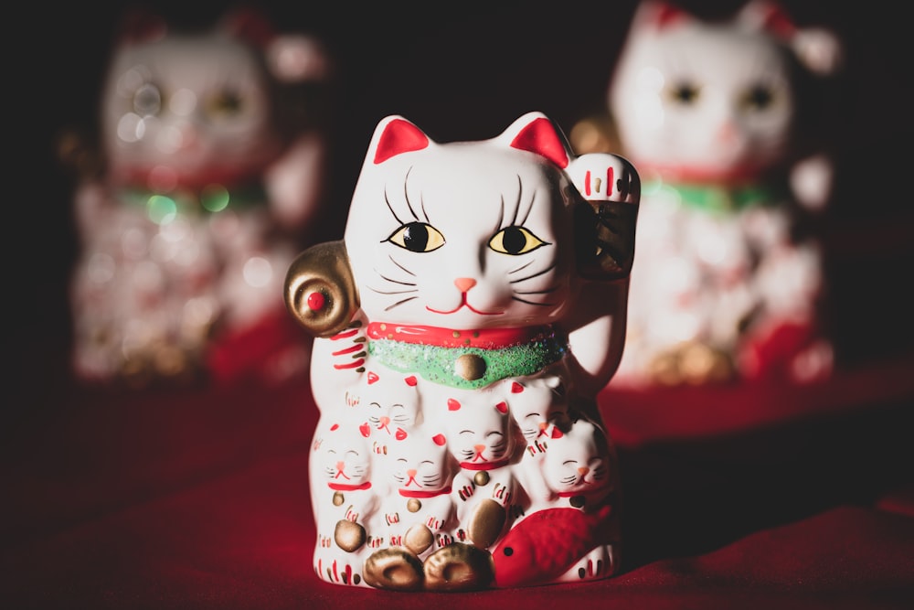 Statuetta di gatto in ceramica bianca e rossa