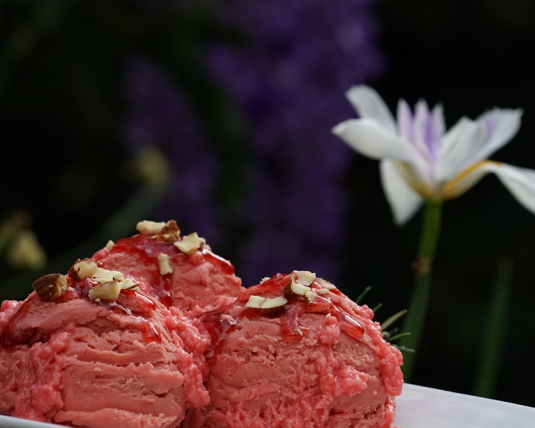 white and pink flower beside brown bread