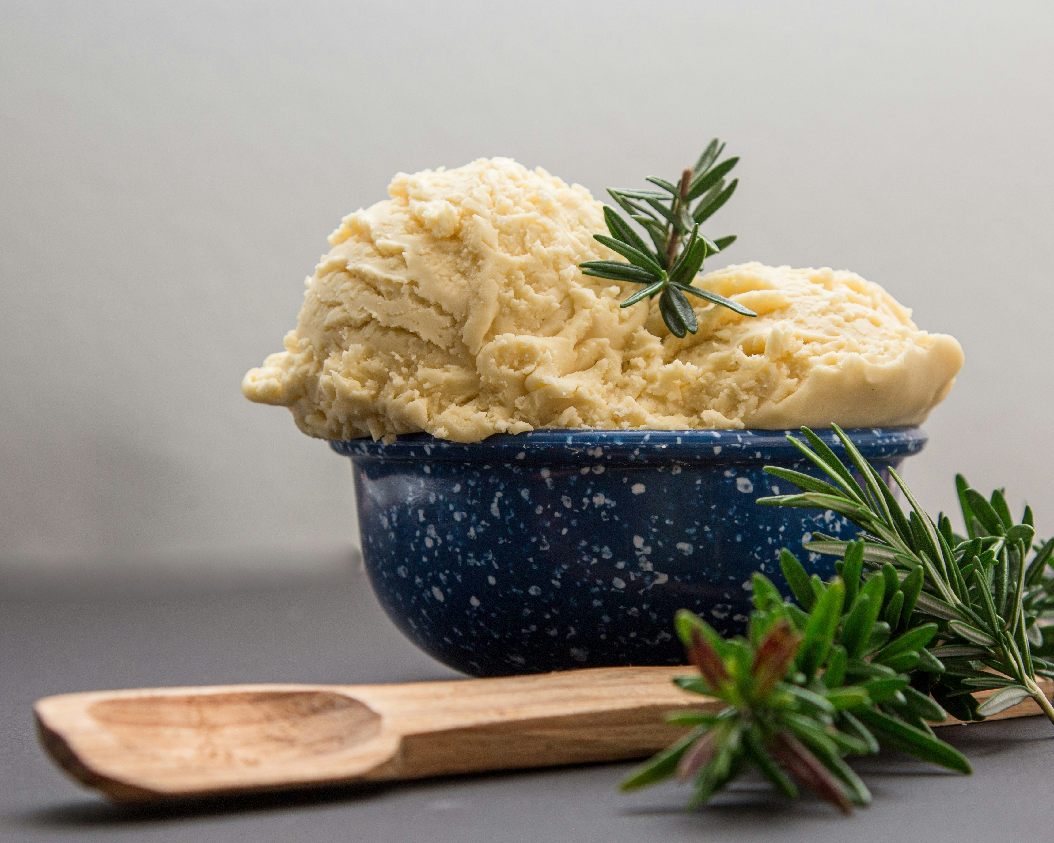 brown wooden spoon on blue ceramic bowl