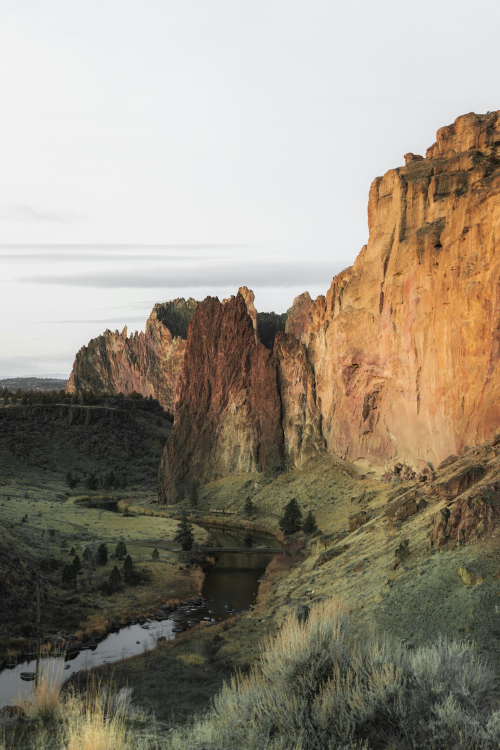 brown rock formation near body of water during daytime