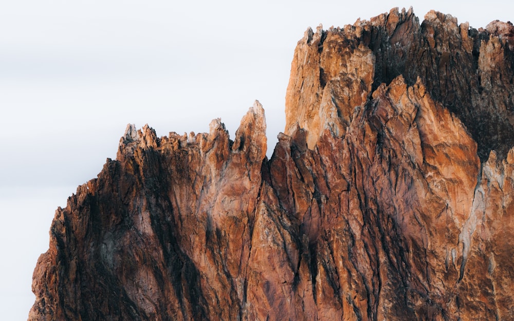 brown rock formation under white sky during daytime