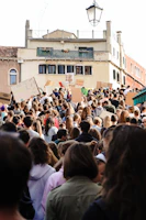 A peaceful protest with diverse crowds holding colorful banners in a European square.