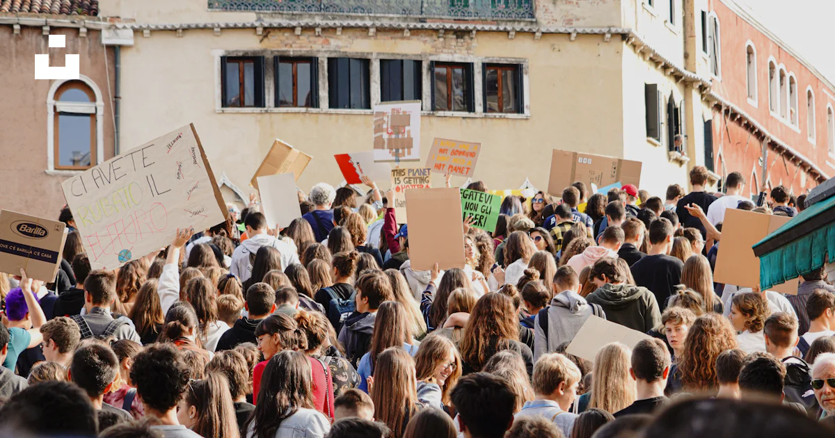 Congregating People gathering in front of brown building during daytime photo – Free ...