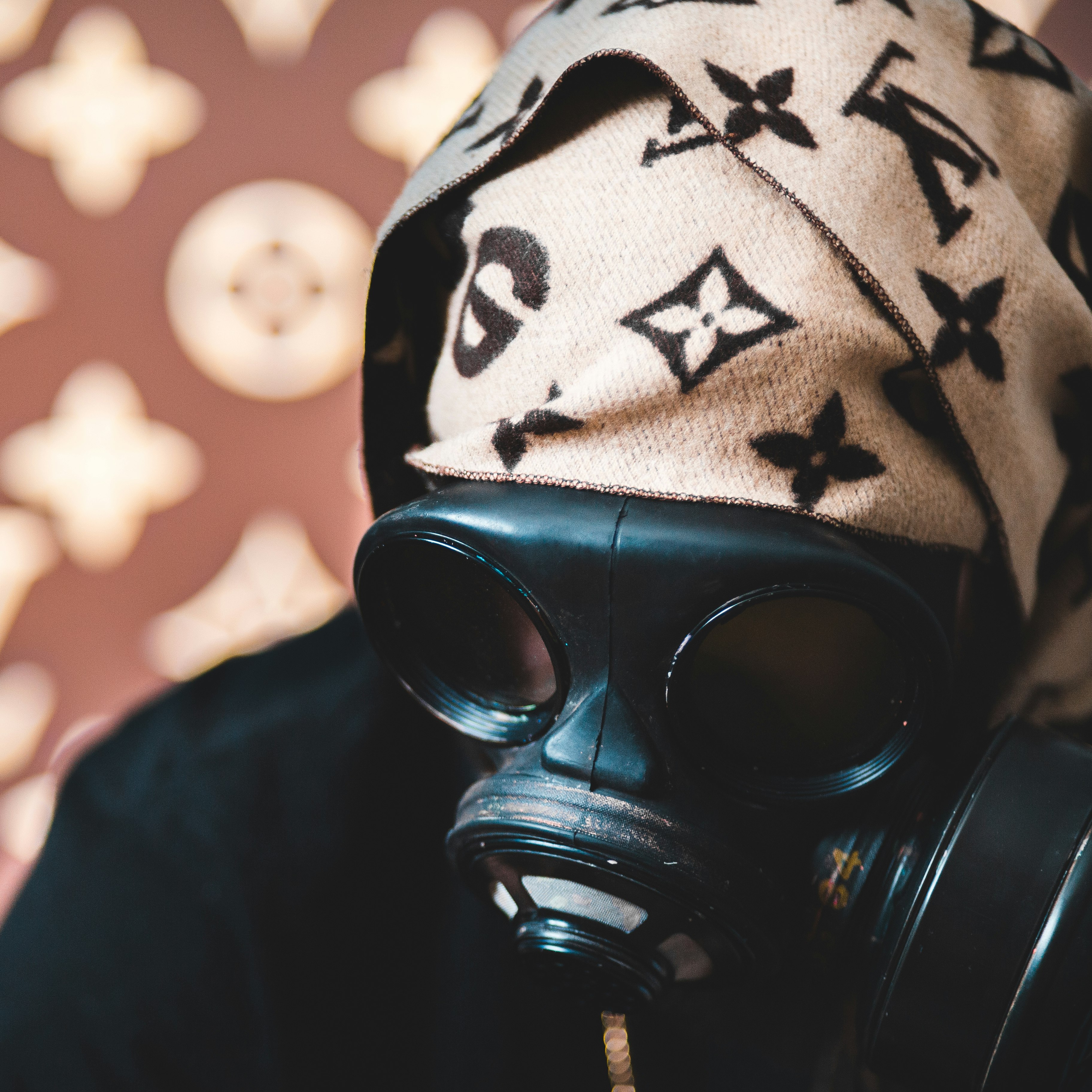 person wearing black and white knit cap and gas mask