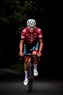 man in red and black bicycle suit riding on black and red bicycle