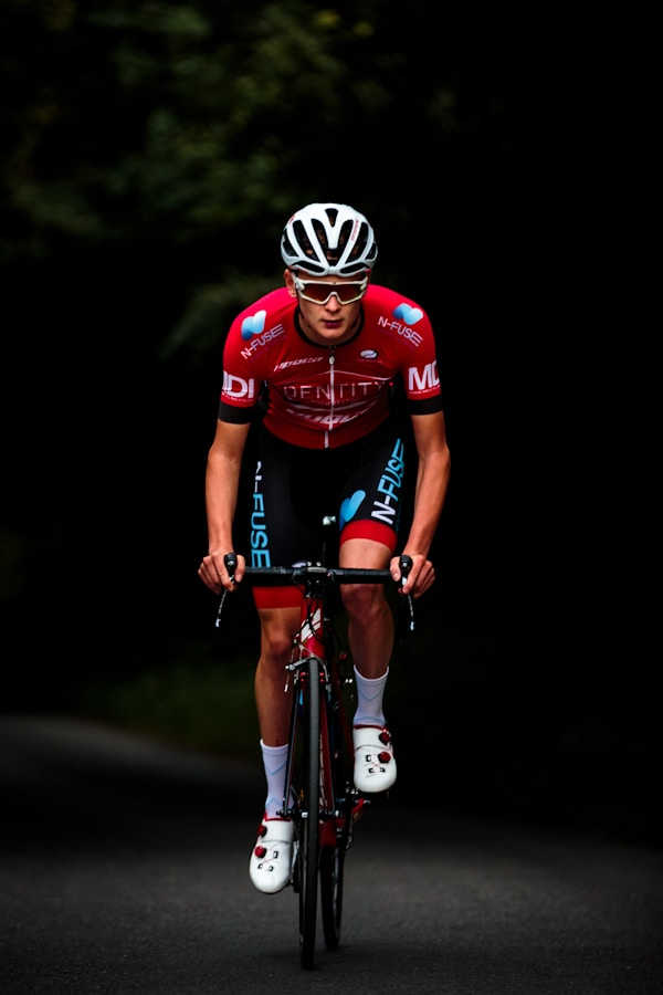 Cyclist riding up hill in red kitby Chris Kendall