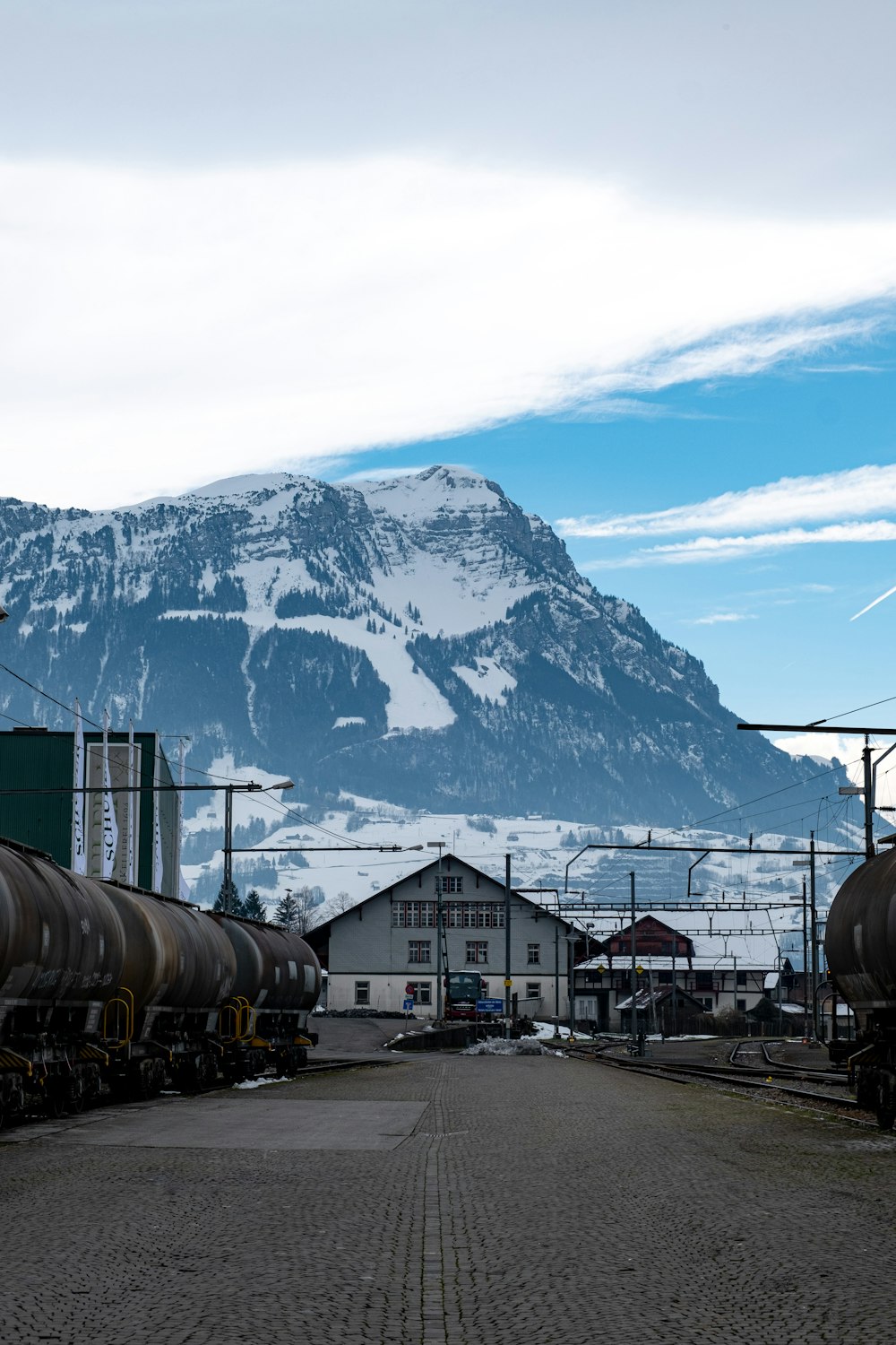 white and brown train near snow covered mountain during daytime