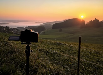 A panoramic view of a camera crew capturing a dramatic outdoor scene at golden hour.