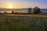 A serene landscape with a sunrise over a calm lake, symbolizing new beginnings.