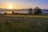 A serene landscape with a sunrise illuminating a calm lake, symbolizing new beginnings and inspiration.