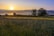 A serene landscape with a sunrise illuminating a calm lake, symbolizing new beginnings and inspiration.