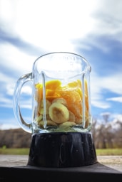 clear glass mug with black liquid inside