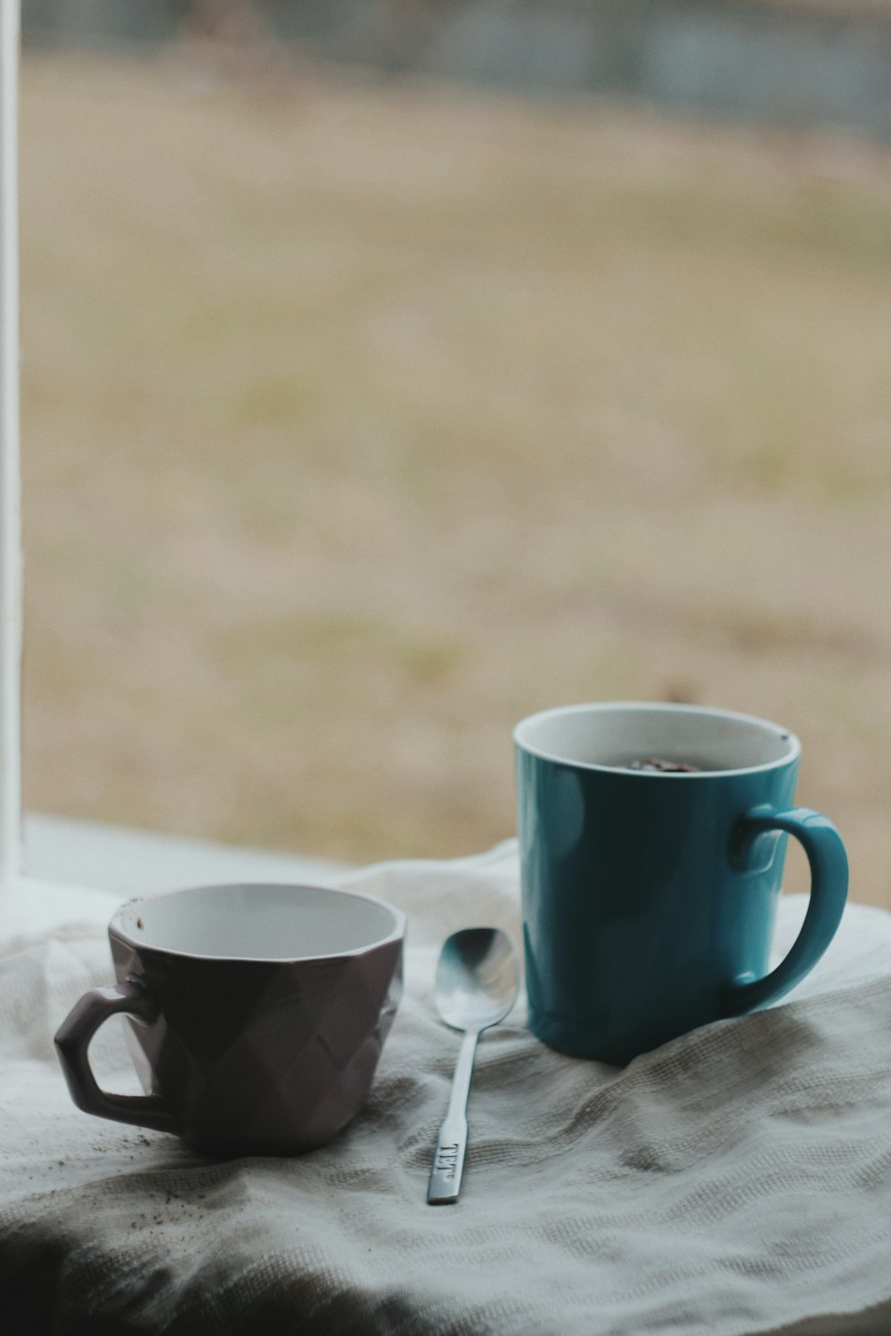 2 white ceramic mugs on white table