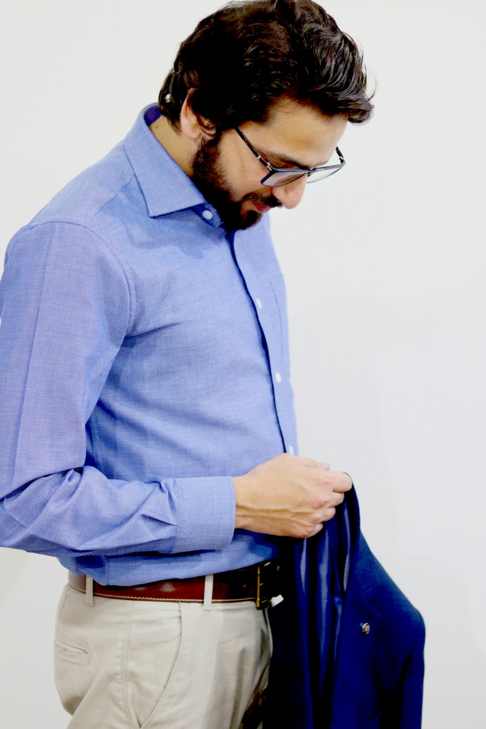 man in blue dress shirt wearing black framed eyeglasses