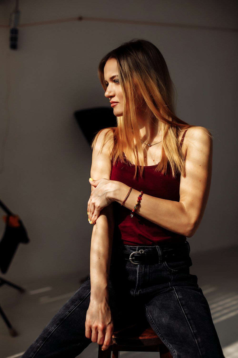 woman in red tank top and black denim jeans