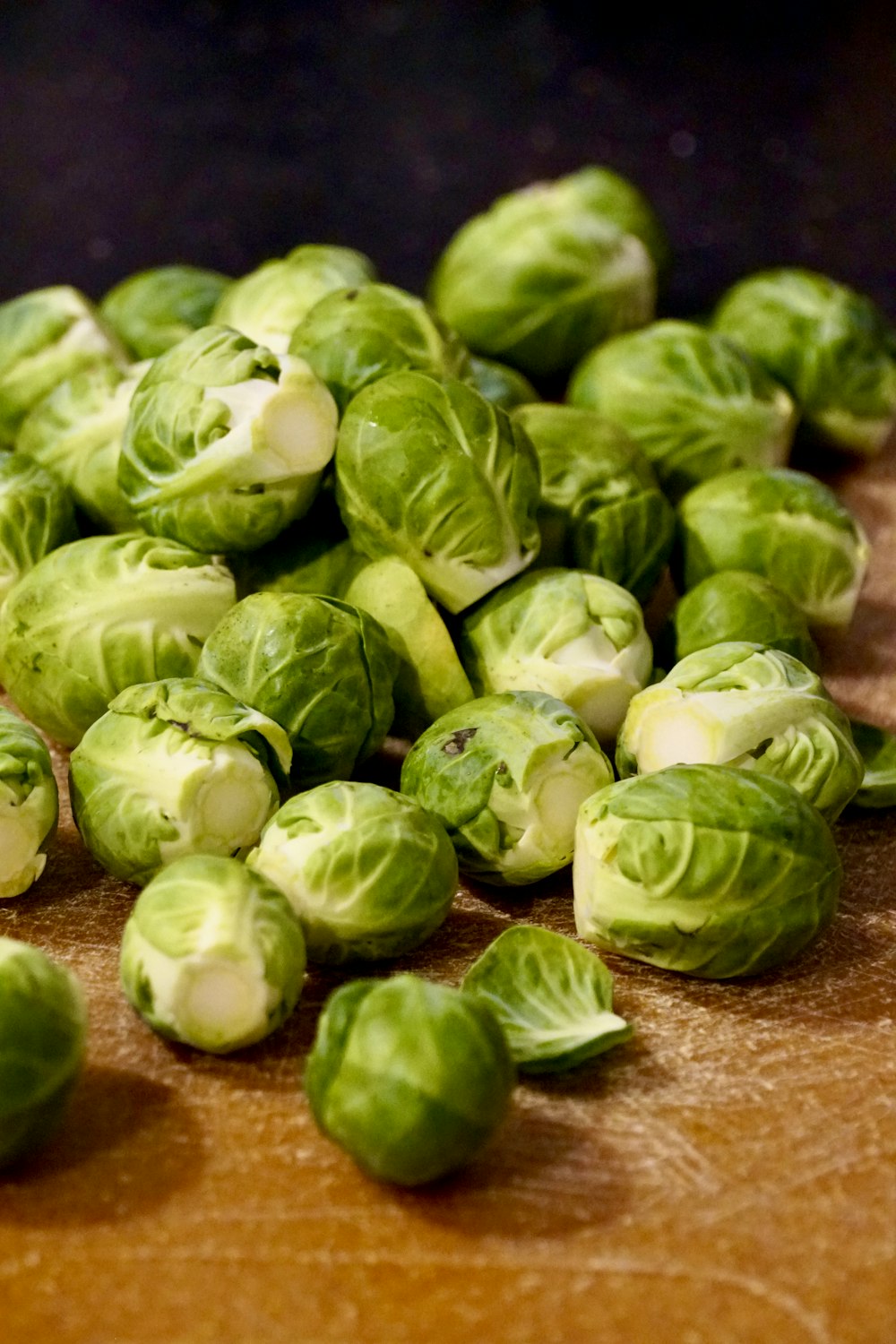 green and white vegetable on brown wooden table