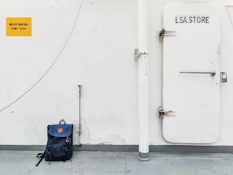 blue and black backpack on black luggage bag