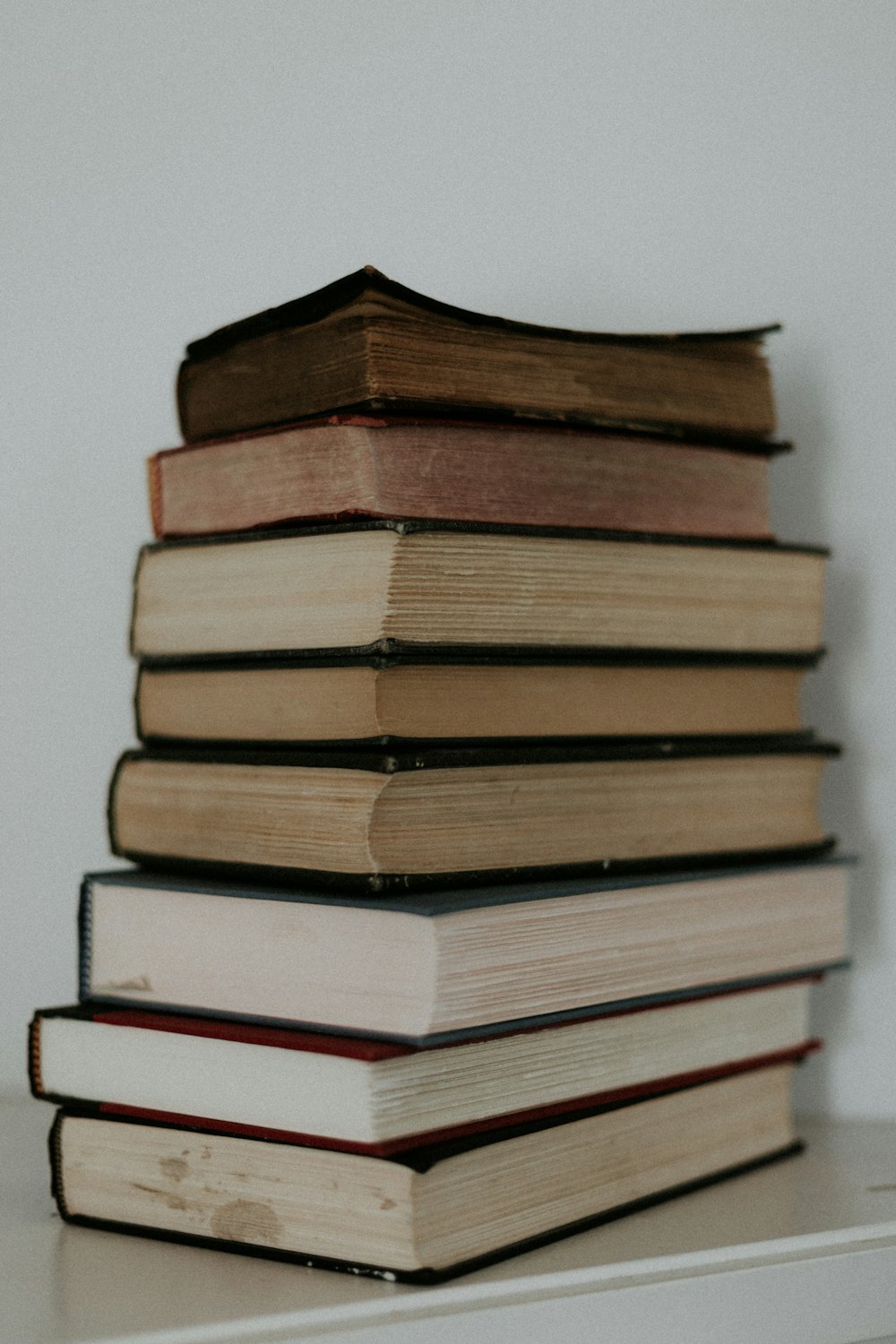 stack of books on white table