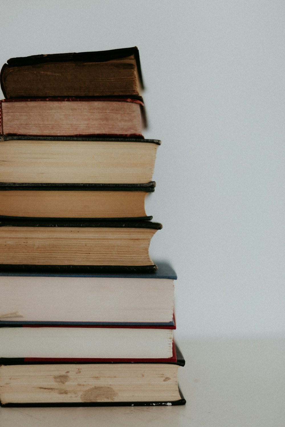 brown and white books on white table