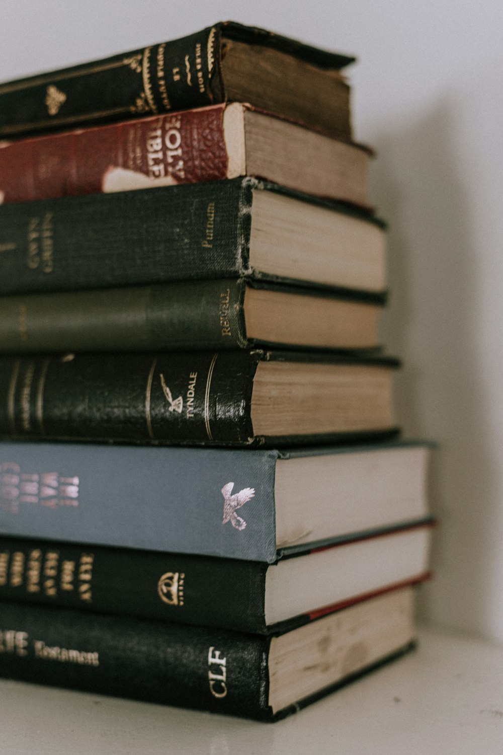 piled books on white table