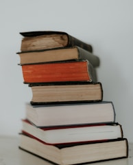 brown and red books on white surface