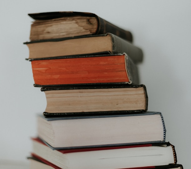 brown and red books on white surface