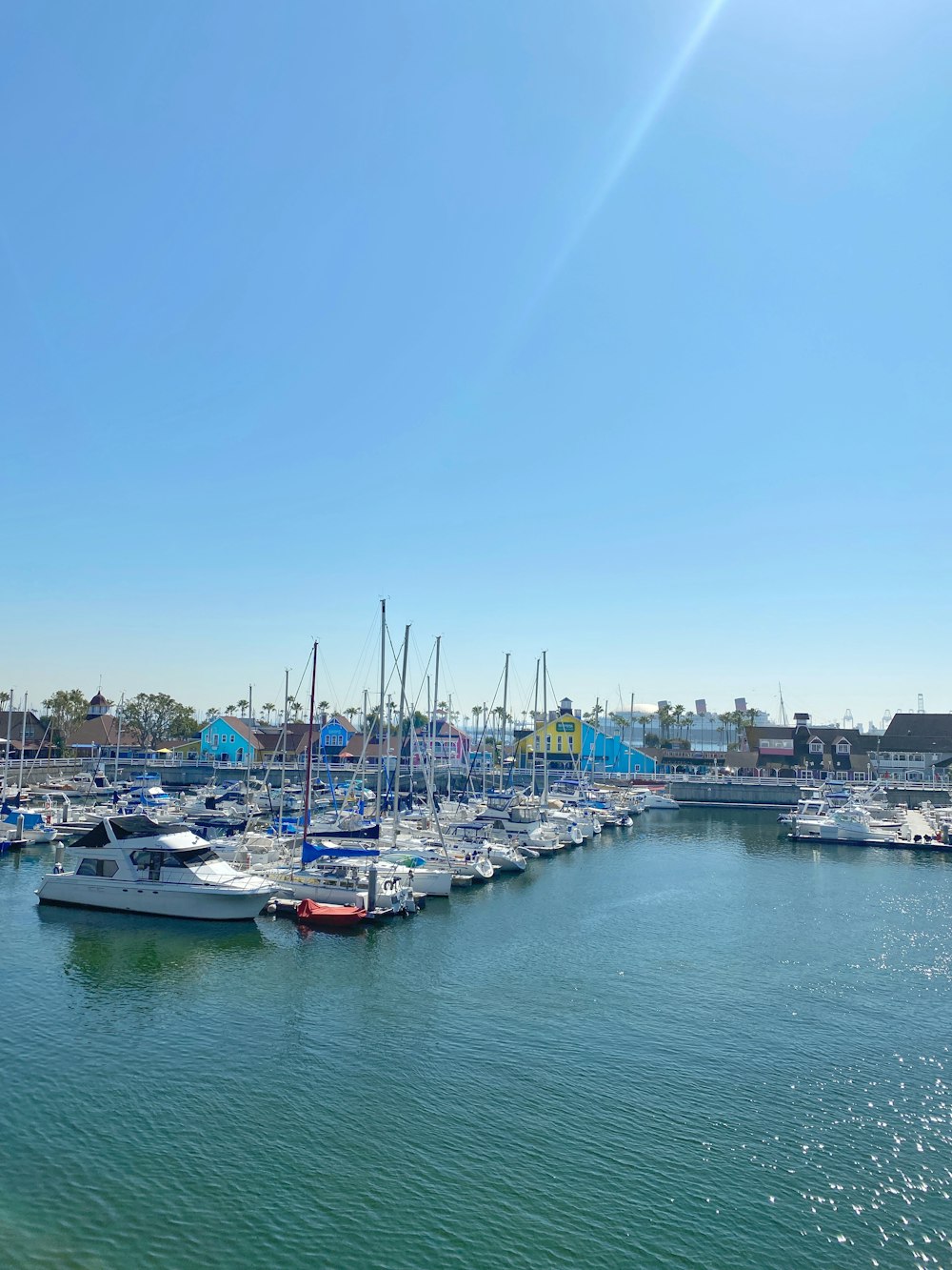 white and blue boats on sea during daytime