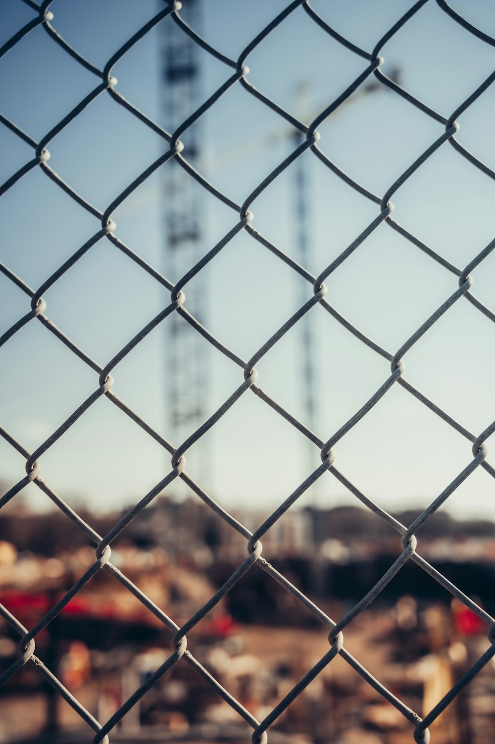 a view of a construction site through a chain link fence