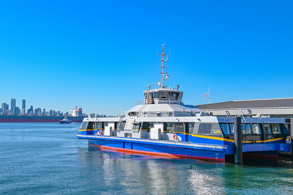 blue and white boat on sea under blue sky during daytime