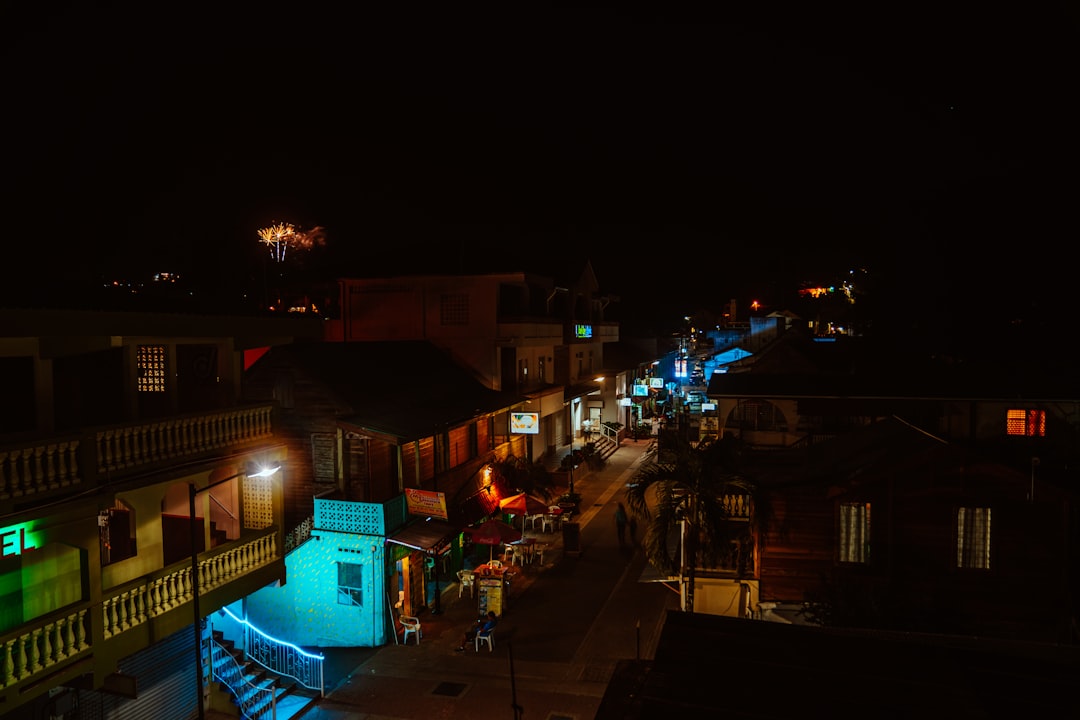 people walking on street during night time, Markets along the street in downtown San Ignacio.