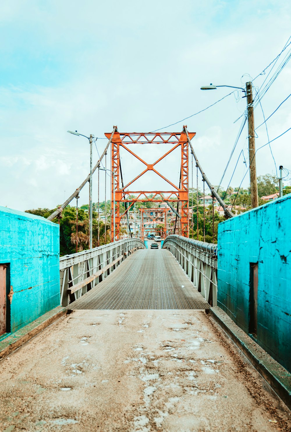 a bridge that is over a dirt road