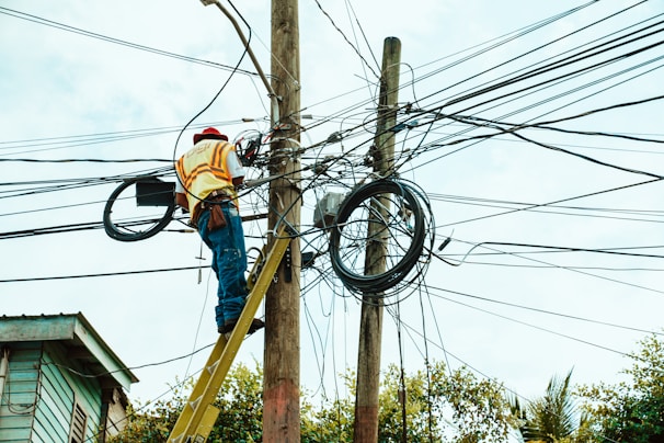 Technician installing fiber optic cables in a residential neighborhood