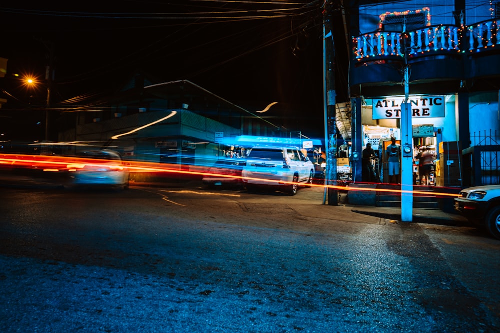 blue and white bus on road during night time
