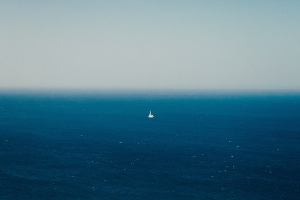 white sailboat on blue sea during daytime