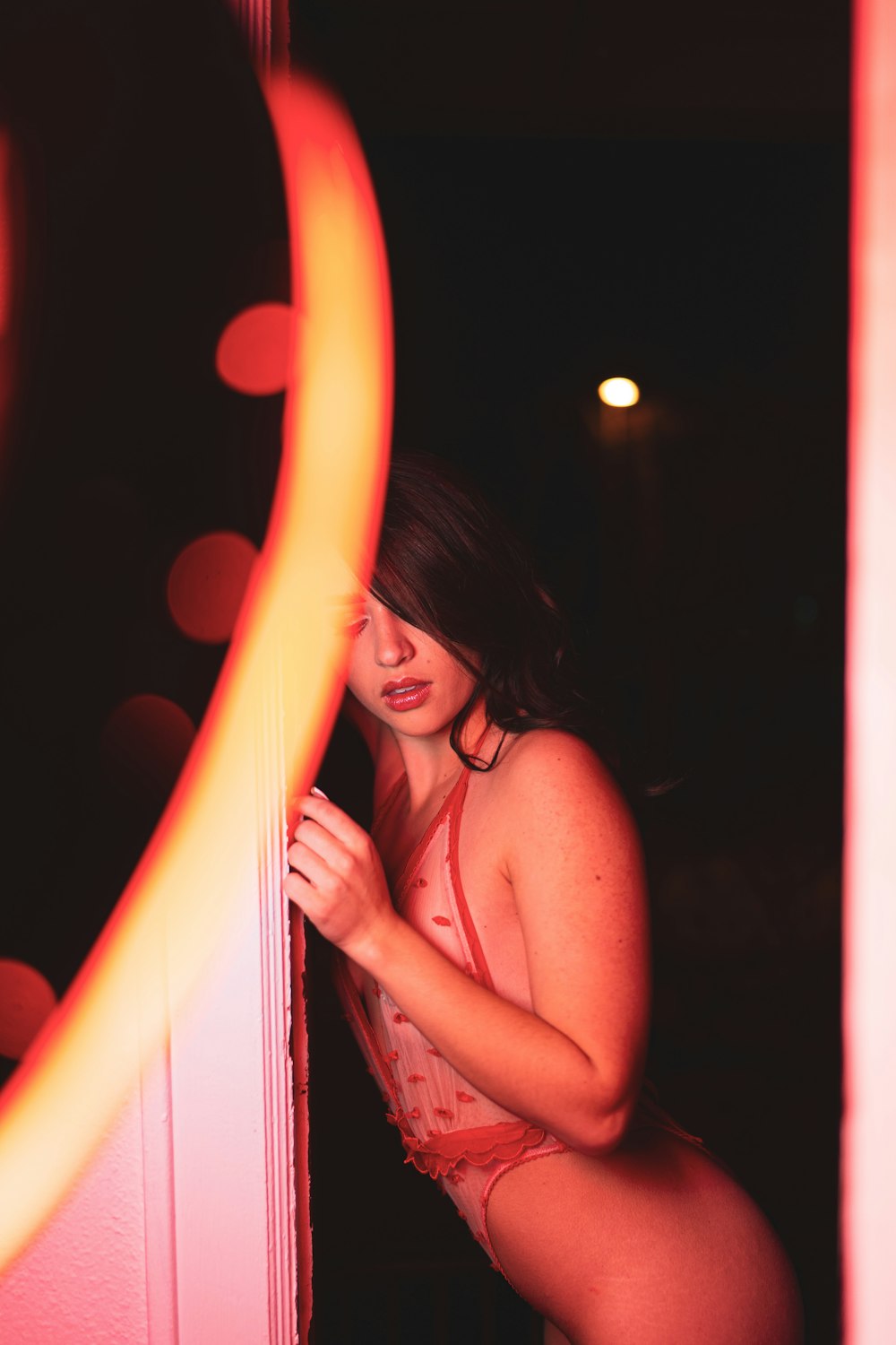 topless woman holding orange light