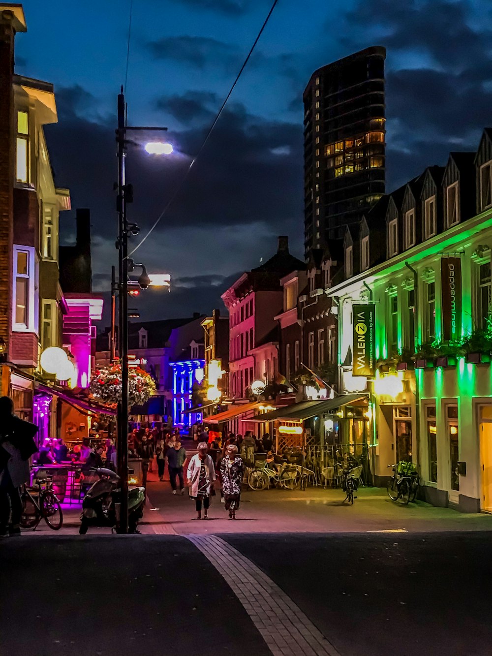 people walking on street during night time