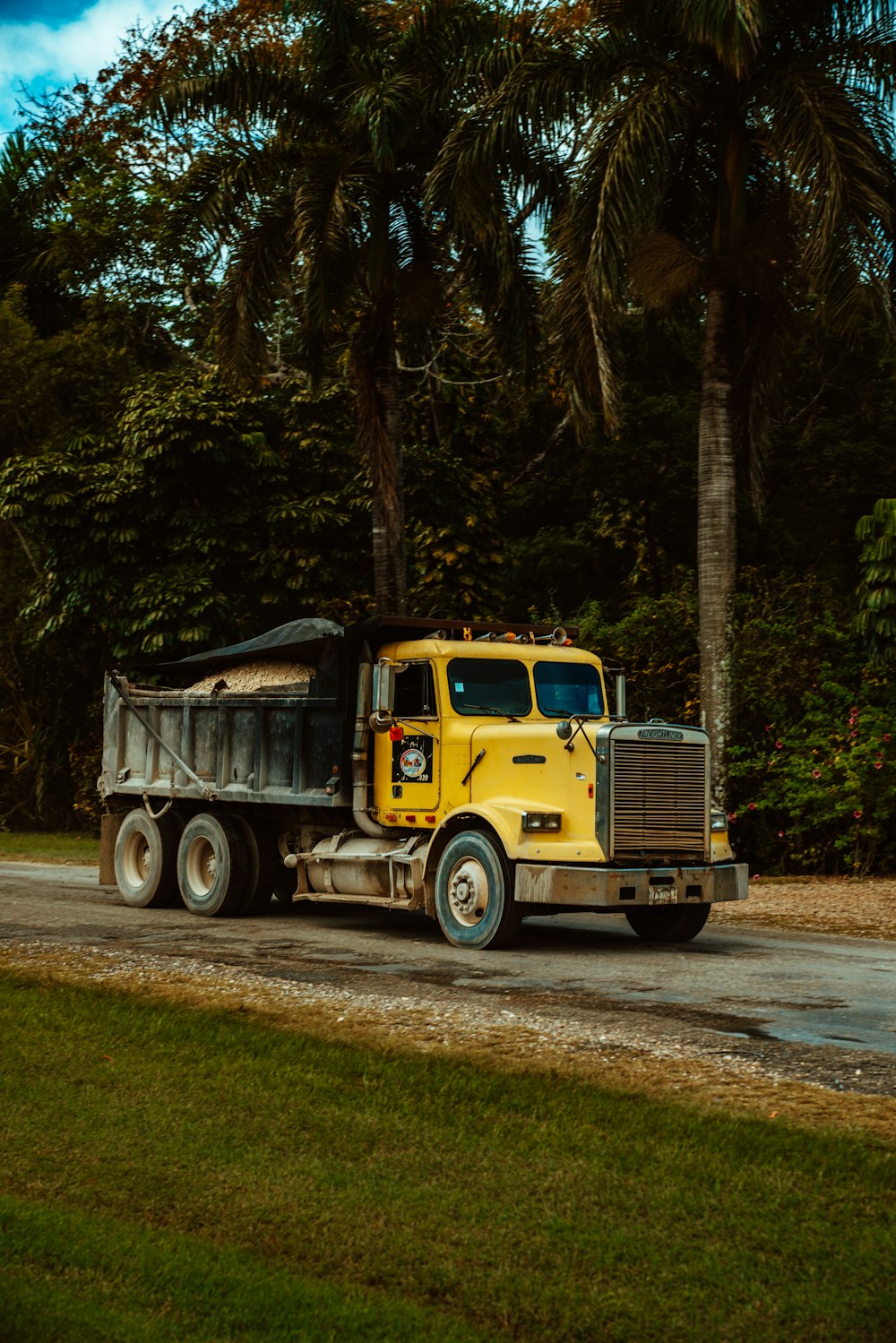 yellow truck on road during daytime