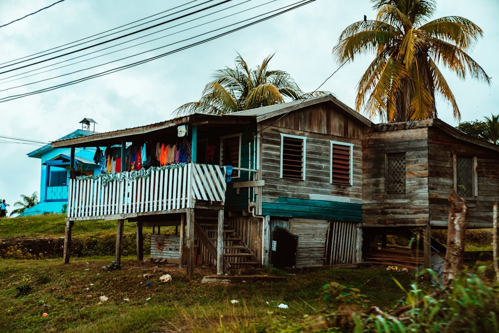 blue and white wooden house near palm trees during daytime