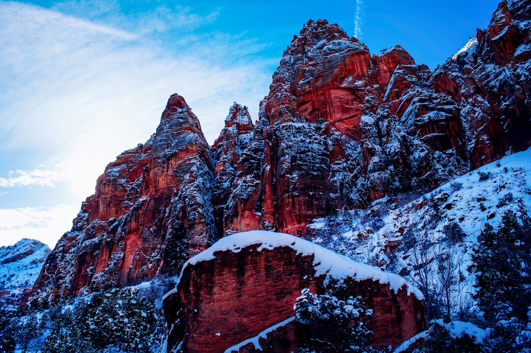 brown rocky mountain covered with snow during daytime