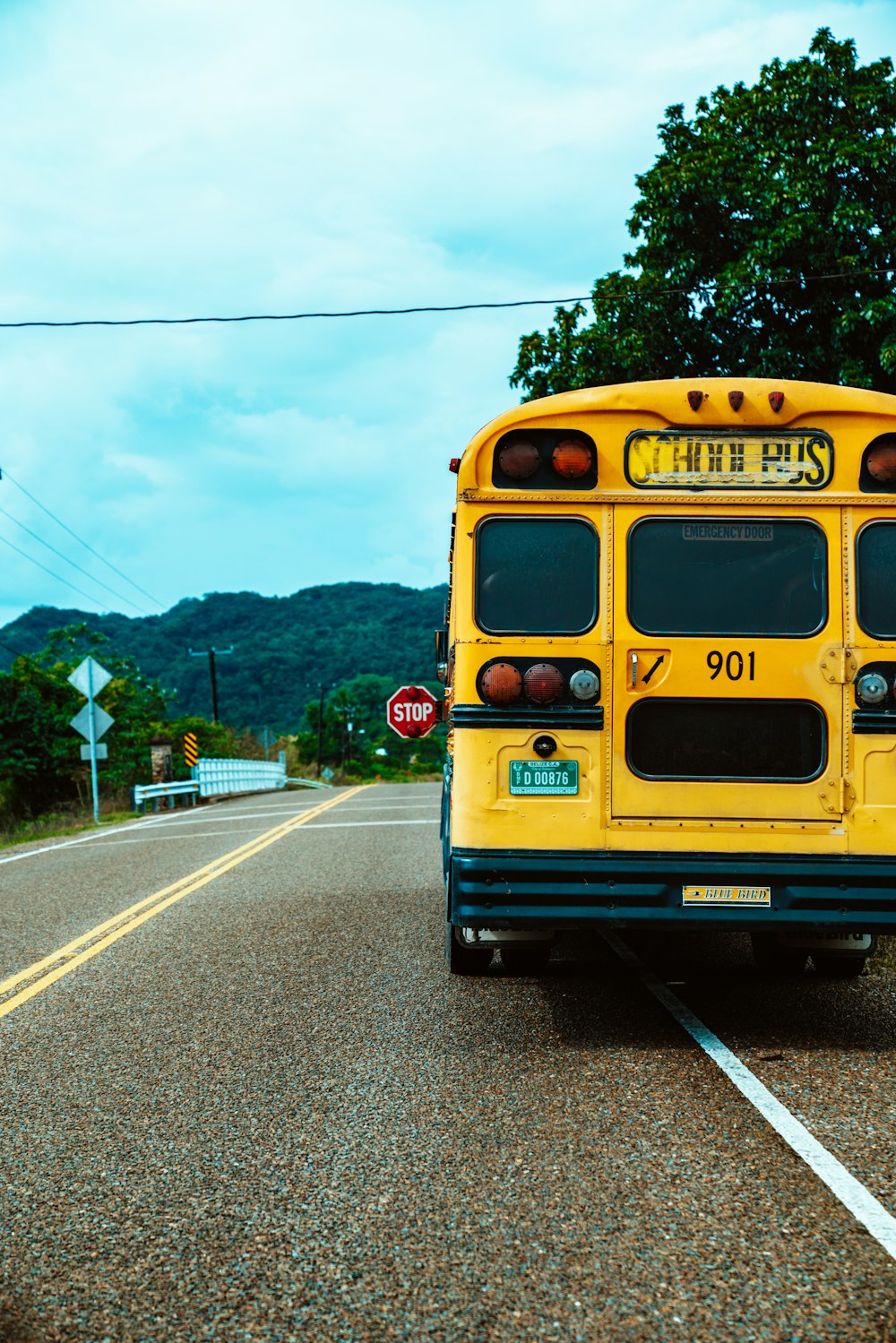 yellow school bus on road during daytime