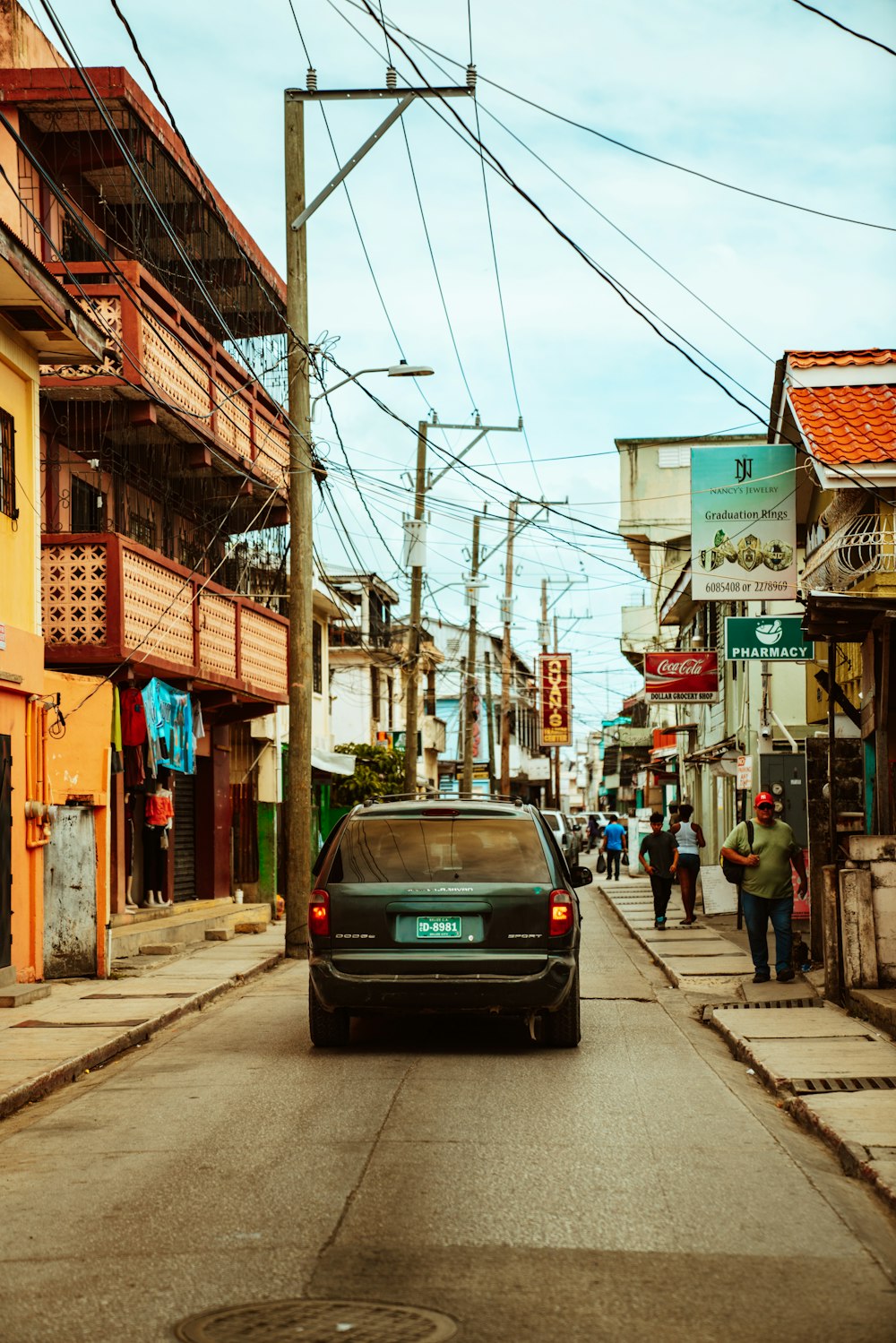 black car on road near buildings during daytime