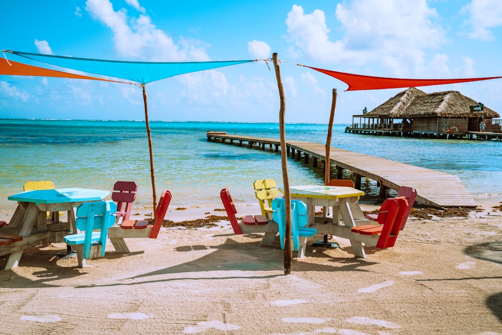 brown wooden beach lounge chairs on beach during daytime