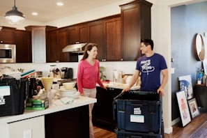 woman in blue crew neck t-shirt standing in kitchen