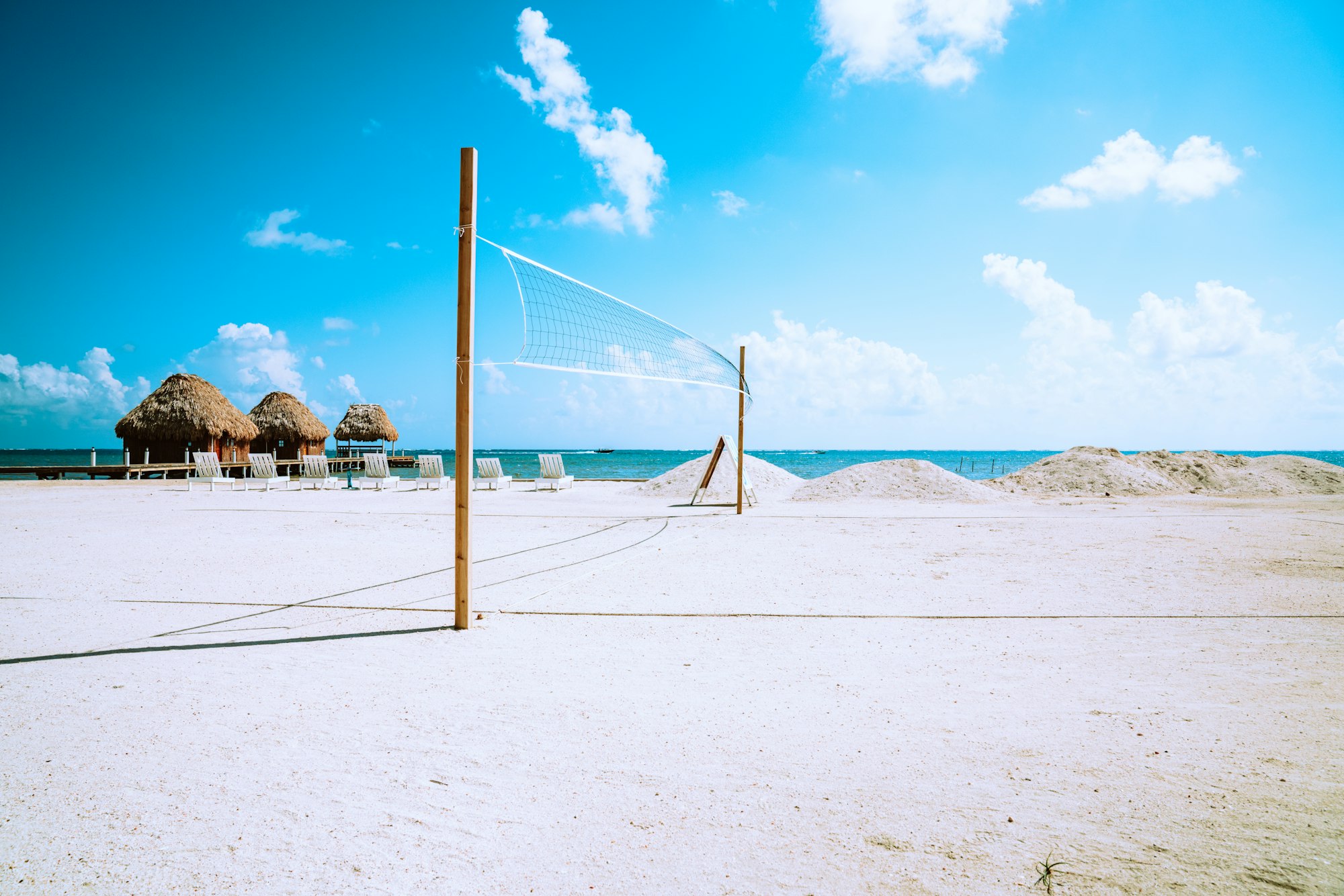 Volleyball net on the white sands of a tropical beach.